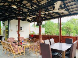 a dining room with a table and chairs at MOSS HEDERA HIDE CHALET in Melaka