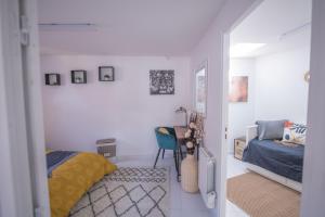 a bedroom with a bed and a couch in a room at Le Charmant Pontault Combault in Pontault-Combault