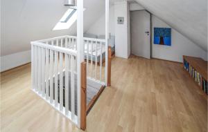 a white staircase in a room with wooden floors at 3 Bedroom Awesome Home In Samsø in Nordby +12 photos