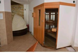 a wooden cabinet in a room with a tub at Katia М14 Milmari Resort in Kopaonik
