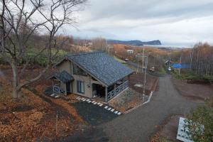 an overhead view of a small house on a road at MATRYOSHKA HOUSE in Yoichi +6 photos