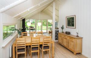 a kitchen and dining room with a wooden table and chairs at Cozy Home In Sams With Kitchen in Kolby Kås