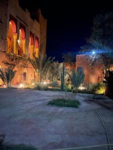a building with a courtyard at night with lights at Ryad lcaid in Tissint