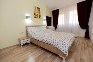 Postel nebo postele na pokoji v ubytování Dodona ApartHotel in Prishtina