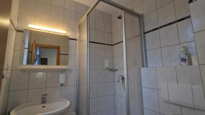 a bathroom with a shower and a toilet and a sink at TH Exclusive in Düsseldorf