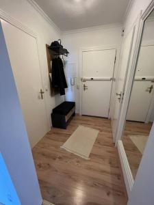 a hallway with two white doors and wooden floors at Schöne Penthouse Wohnung direkt am Deutschen Eck in Koblenz