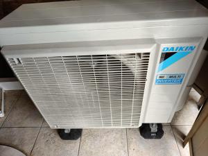 a white radiator sitting on a tile floor at Un balcon sur les toits in Beblenheim