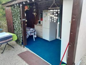 a house with a blue floor and a kitchen at Casa Octavia in Schitul