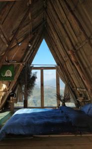 a large bed in a room with a large window at Imani Eco Sky Lodge Ngoc Chien in Nam San