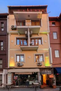a building with balconies and tables in front of it at Vefa Hotel&Suites in Istanbul