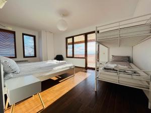 a bedroom with two bunk beds in it at Farmhopping Village in Dobărsko