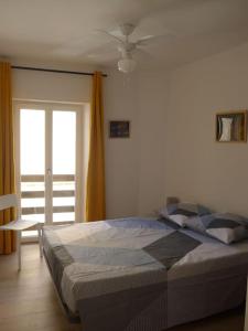 a bedroom with a bed and a sliding glass door at Duplex sur un fameux Grain de sable in Bonifacio