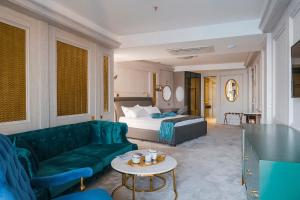 ウルツィニにあるHotel Marisのベッド、ソファ、テーブルが備わるホテルルームです。