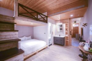 Postel nebo postele na pokoji v ubytování CASA CoMoDo 自在家