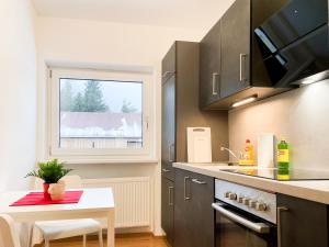 a kitchen with a small table and a window at Haus Sabine in Leutasch