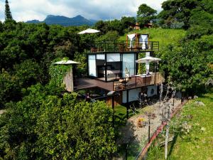 a house on the side of a hill at Oasis Glamping Tena Cundinamarca Cerca a Bogotá in Tena