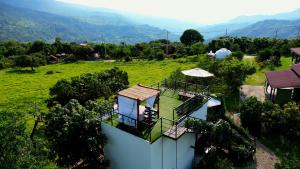 an aerial view of a house in a field at Oasis Glamping Tena Cundinamarca Cerca a Bogotá in Tena