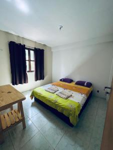 a bedroom with a bed and a wooden table at Casa Tamboril in Sao Jorge