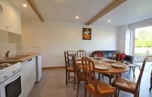 a kitchen and dining room with a table and chairs at La Meunière 2 in Montmerrei +3 photos