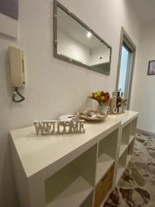 a bathroom counter with a mirror on the wall at Alloggio Ugo Foscolo in Monopoli