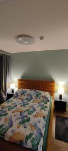 sypialnia z łóżkiem z kolorową kołdrą w obiekcie Apartament Nad Zalewem Zegrzyńskim w Serocku
