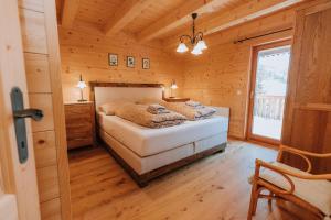 a bedroom with a bed in a wooden cabin at Chalet Aconitum in Murau