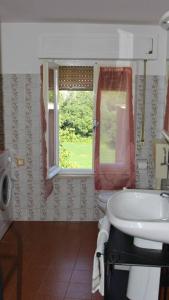 un bagno con lavandino e finestra di Verde e tranquillità a Fucicchie a Cagli