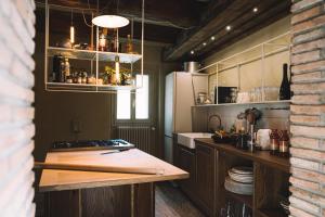 a kitchen with a counter top and a refrigerator at Casa immersa nelle colline romagnole in Civorio