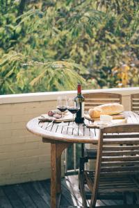 a wooden table with a bottle of wine and glasses at Casa immersa nelle colline romagnole in Civorio +25 photos