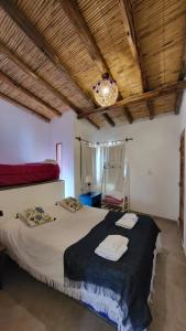 a bedroom with a large bed with two towels on it at Imagine duplex in Purmamarca