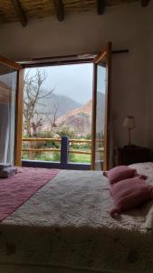 a bedroom with a bed and a large window at Imagine duplex in Purmamarca