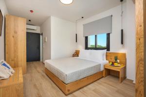 a bedroom with a large bed and a table at AlexMare Hotel Fourka in Skala Fourkas