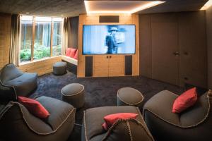 a room with chairs and a flat screen tv at Grand Chalet de Rougemont in Rougemont