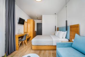 a hotel room with a bed and a desk at AlexMare Hotel Fourka in Skala Fourkas