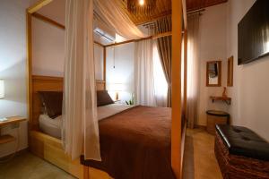 a bedroom with a bed and a large mirror at Jasmine Stoupa in Stoupa