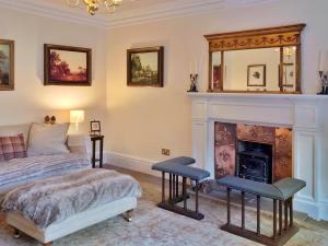 格拉斯哥The West Highland Way Hotel Accommodation的带床和壁炉的卧室