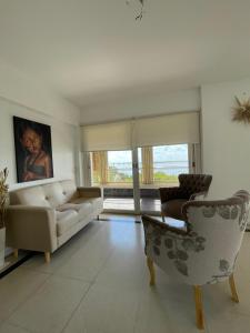 a living room with a couch and two chairs at Bitcoins House Costanera in Corrientes
