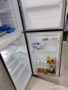 an open refrigerator filled with lots of food and drinks at UNIE HOMESTAY in Wakaf Che Yeh
