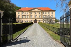 a large house with a driveway in front of it at Chalupa u golfu Kořenec in Kořenec