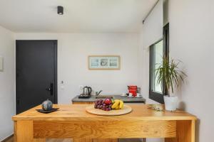 a kitchen with a wooden table with fruit on it at AlexMare Hotel Fourka in Skala Fourkas