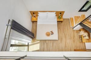 a bedroom with a bed and wooden floors at AlexMare Hotel Fourka in Skala Fourkas
