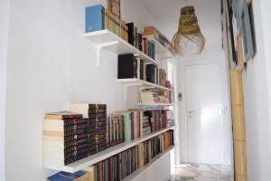 a hallway with white bookshelves filled with books at casanicky in Mijas
