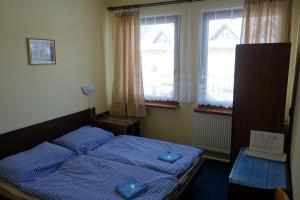 Voodi või voodid majutusasutuse Hotel Sklárna Harrachov toas