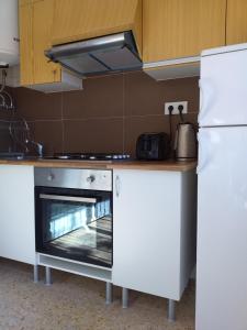 a kitchen with a stove and a refrigerator at El nispero in Peniscola