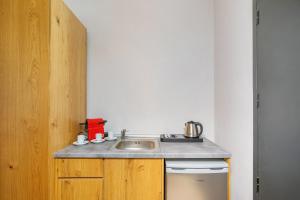 a kitchen counter with a sink and a dishwasher at AlexMare Hotel Fourka in Skala Fourkas