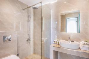 a bathroom with a sink and a shower at AlexMare Hotel Fourka in Skala Fourkas
