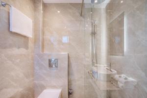 a bathroom with a shower with a toilet and a sink at AlexMare Hotel Fourka in Skala Fourkas