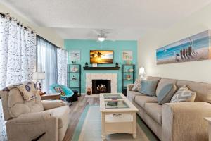 a living room with a couch and a fireplace at Madeira Beach Yacht Club 357H in St. Pete Beach