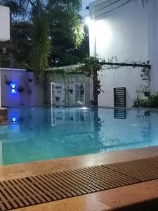 a swimming pool in a house at night at Ibis in Udawalawe