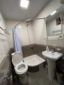 a bathroom with a toilet and a sink at Mutara Bukhara in Bukhara